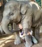 Elephant Nature Park Lek accepts a playful smooch from Faa Mai's trunk.